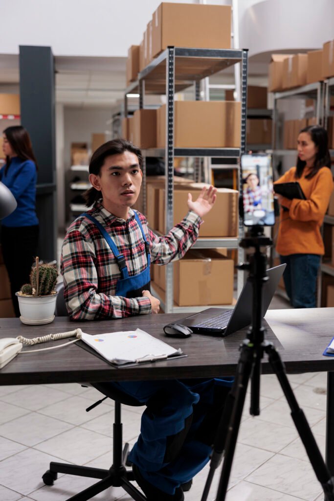 Warehouse worker recording smartphone video with stock promotion